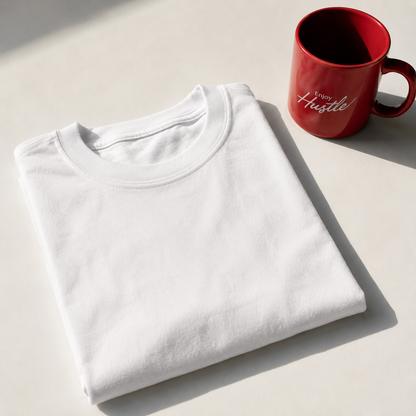 Folded white t-shirt with red mug, flat lay
